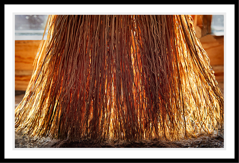 A broom that is backlit.
